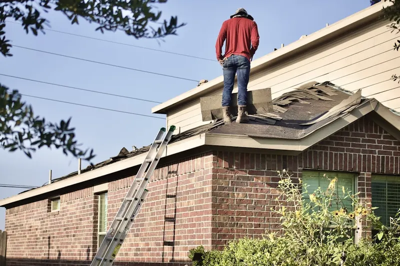 Professional roofer working on a residential roof in Eastport